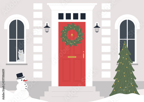 A decorated building entrance, a Christmas wreath on the door, a Xmas tree, winter holidays