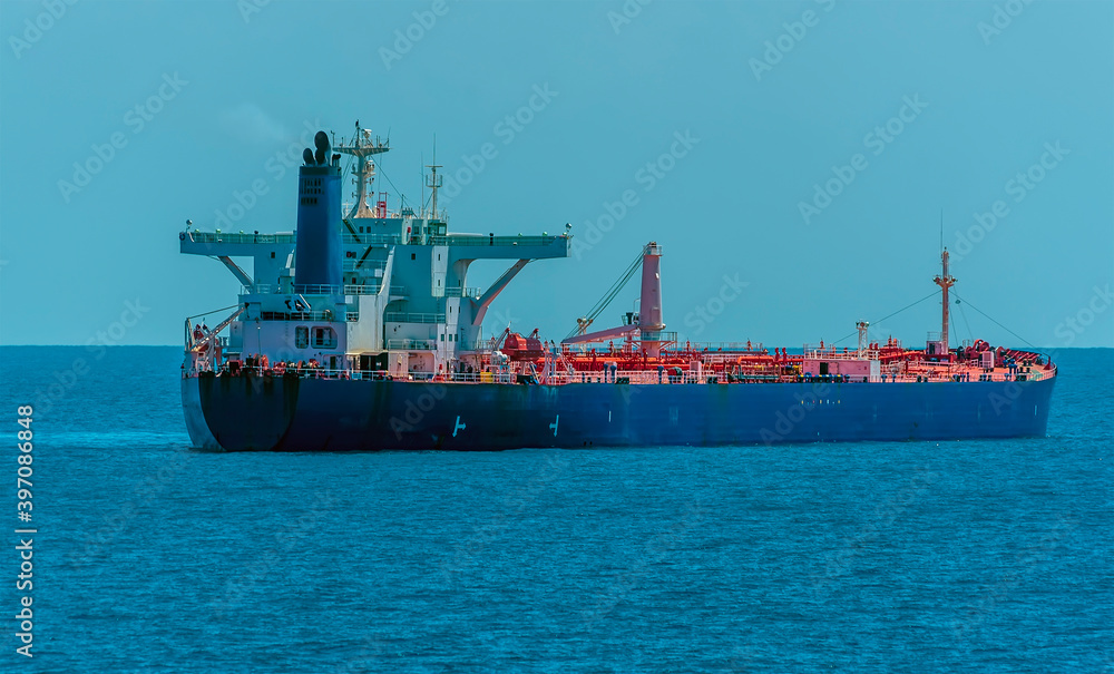 A loaded tanker ship at sea approaching the Singapore Straits in Asia in summertime