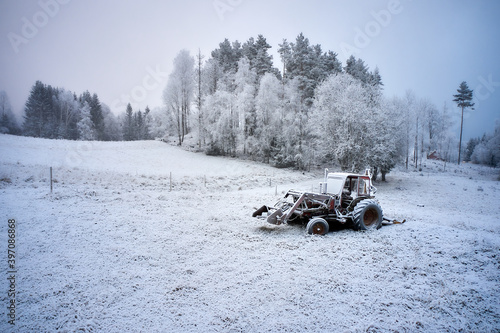 Old tractor sitting in a frozen field. Sørekedalen, Oslo, Norway