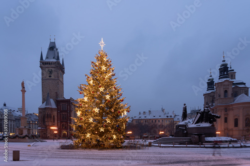 Christmas tree and the Old Town Square in Prague, Czech Republic, covered by fresh snow. No Christmas markets organized in 2020 due to Covid-19