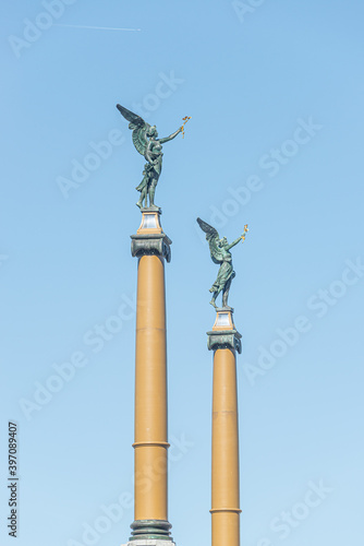 Statue of beautiful angels with wings at the top of columns in Prague historical downtown, Czech Republic, details, at blue sky with copy space for text.