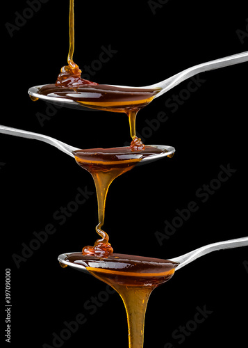 Close up Golden sweet honey dripping from spoon