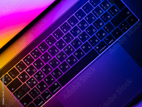 MacBook Pro keyboard illuminated by gradient