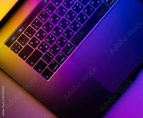 MacBook Pro keyboard illuminated by gradient