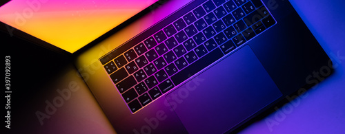 MacBook Pro keyboard illuminated by gradient photo