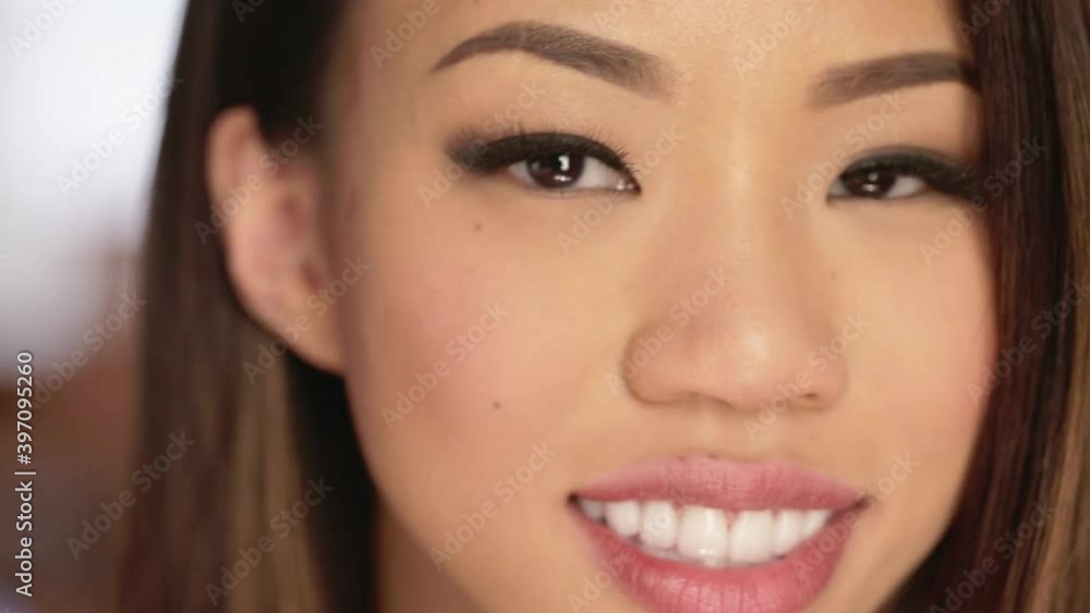 Smiling Asian woman looking at camera Smiling Asian woman looking at camera