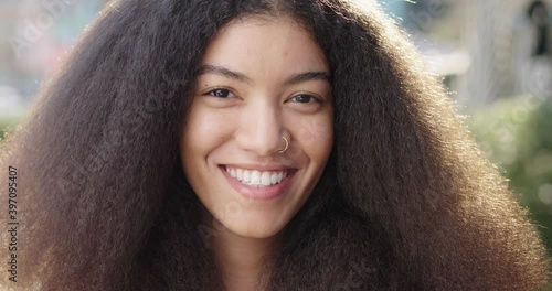 Portrait of young woman with long hair smiling at camera photo