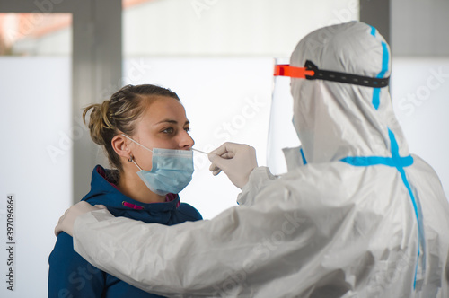 Medical staff member with mask, rubber gloves and protective equipment in covid testing center