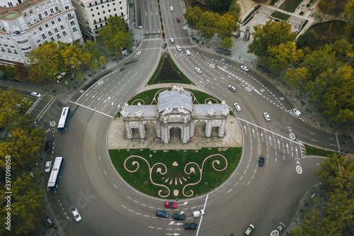 look from above view aerial drone shot Spain Madrid capital cloudy buildings traffic Puerta de Alcalá