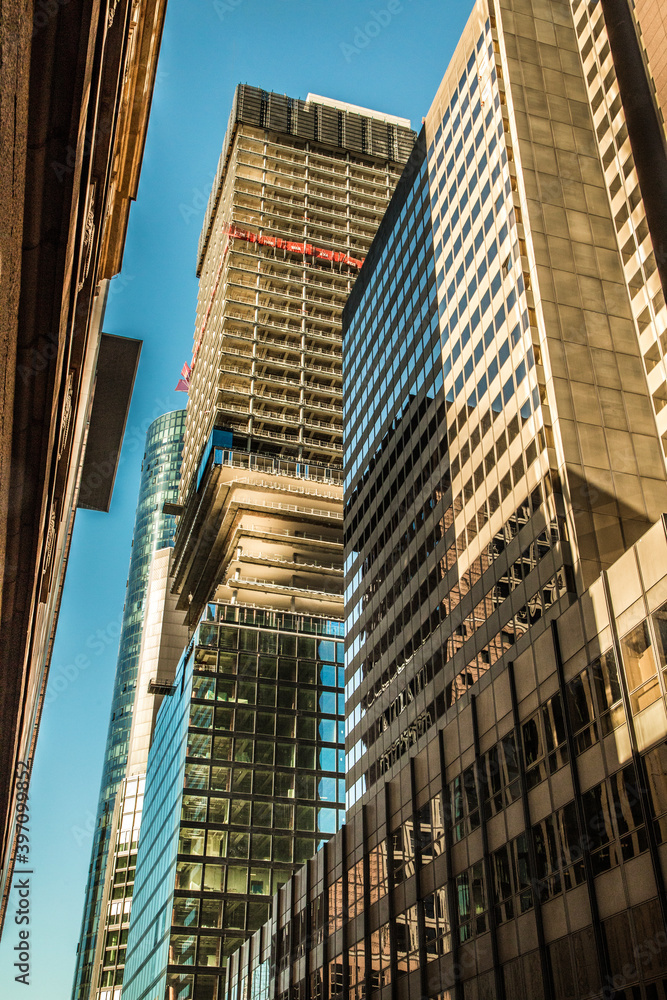 Frankfurt on Main, Germany, 27 september 2018. Modern beautiful new skyscraper in the bussines part of the city against the blue sky on a sunny day without people a wide viewing angle Frankfurt on Main, Germany, 27 september 2018. Modern beautiful new skyscraper in the bussines part of the city against the blue sky on a sunny day without people a wide viewing angle