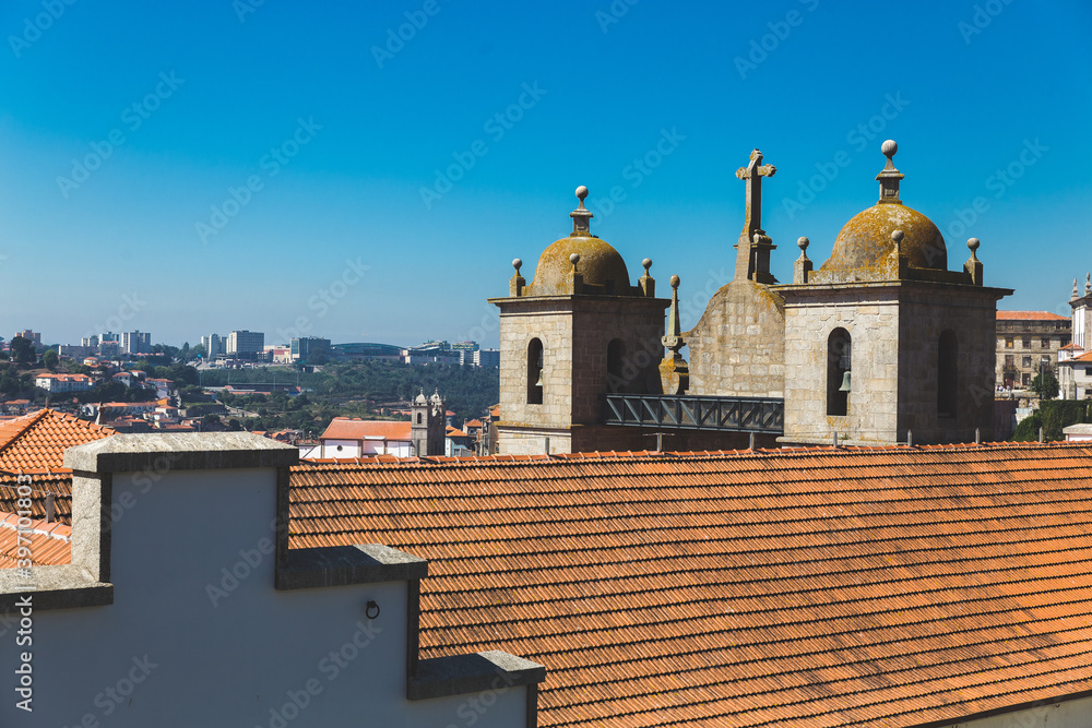 Porto Portugal old houses building colorful roofs rooftops orange red tower crossblue sky daylight sunny