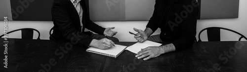 hands of people at the negotiation table, black and white