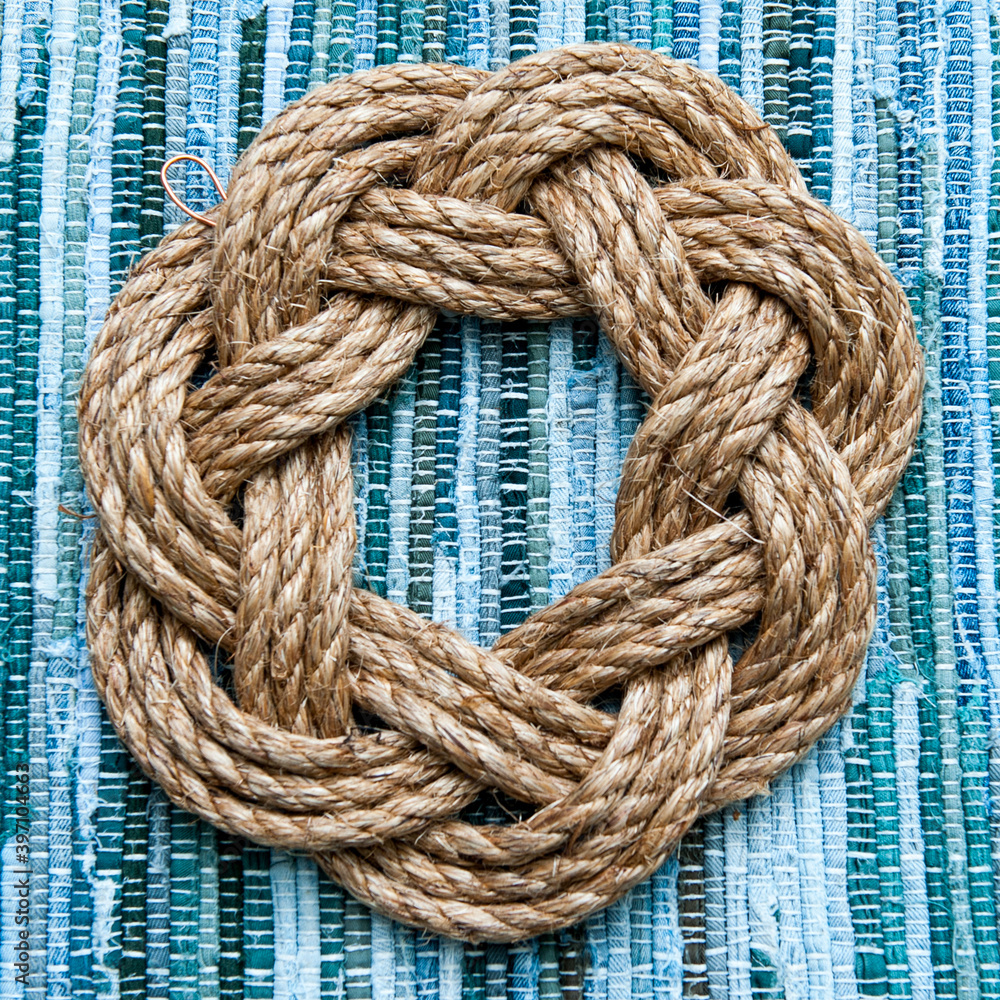 Plain nautical wreath on green weaved background