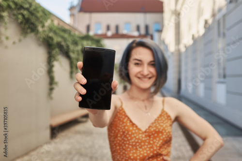 Cute  smiling women shows phone