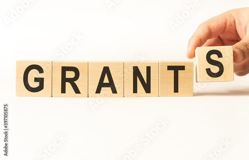 Word grants. Wooden small cubes with letters isolated on white background with copy space available.Business Concept image.
