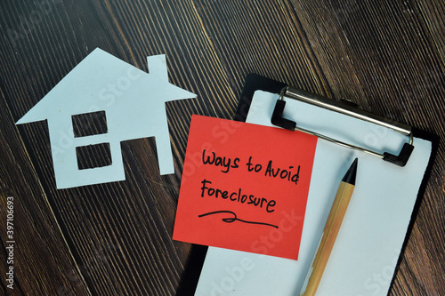 Ways to Avoid Foreclosure write on sticky notes isolated on Wooden Table. photo