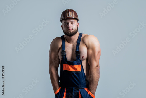 muscular man architect with strong body. guy wear worker uniform. athletic builder in helmet. sexy man with body muscles. professional constructor or mechanic. builder engineer © be free