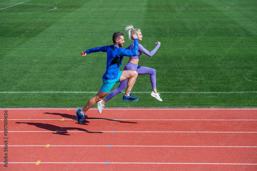 athletic man and sexy woman compete in sprint. male and female coach on stadium running track. healthy lifestyle. marathon speed. sport couple run fast to win. successful fitness sprinters