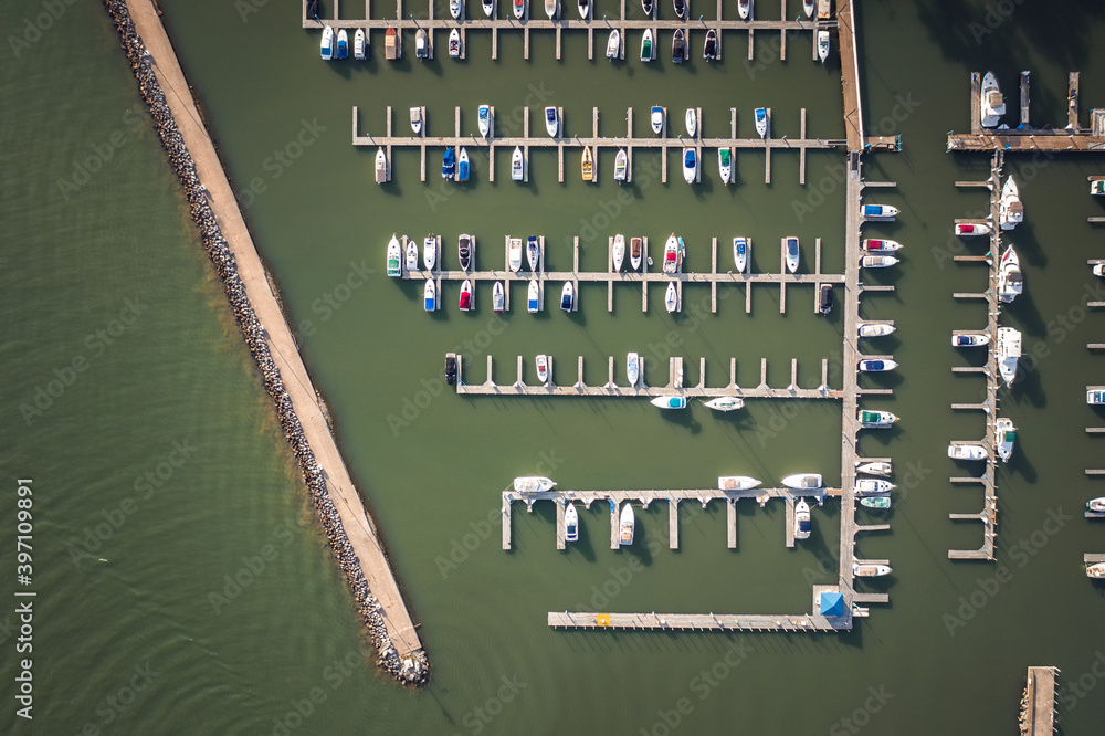Fantastic look down aerial of green colored water and stationary watercraft at a boat harbor looking down at boat docks and piers on Lake Erie in Sandusky Ohio. Fantastic look down aerial of green colored water and stationary watercraft at a boat harbor looking down at boat docks and piers on Lake Erie in Sandusky Ohio.