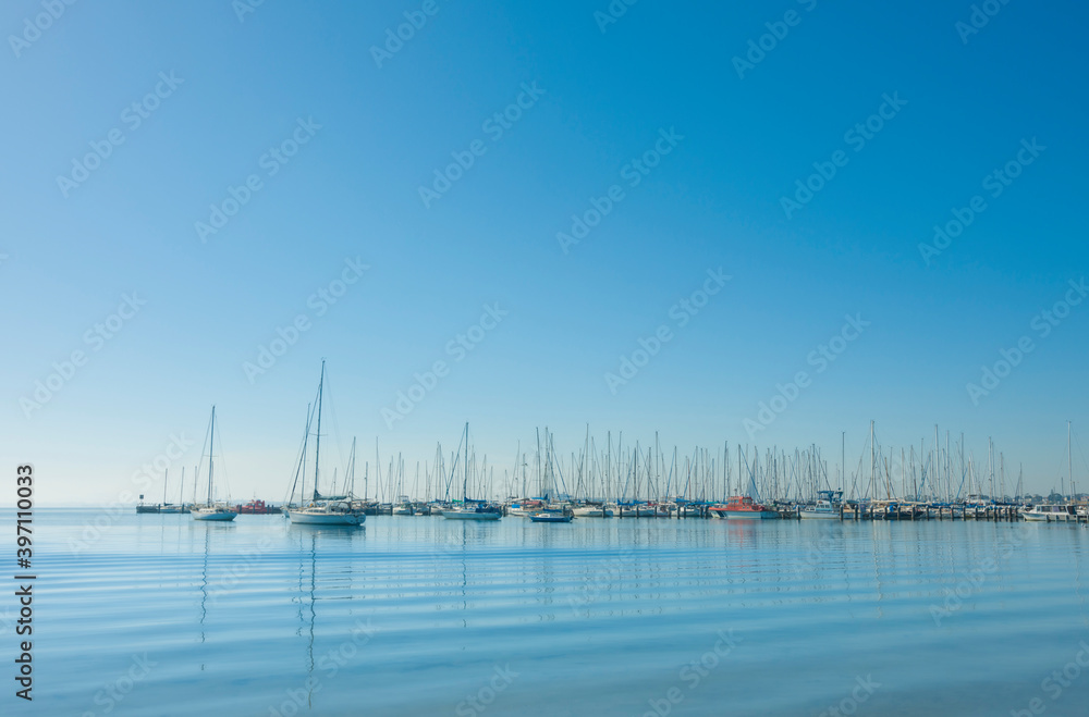 Obraz premium Yachts moored in a tranquil harbour