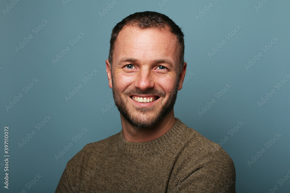 Portrait of a man in front of a colored background