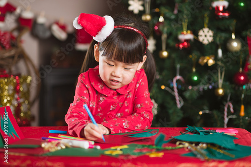 young girl making christmas craft at home