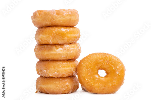 donuts with icing sugar stacked on white background