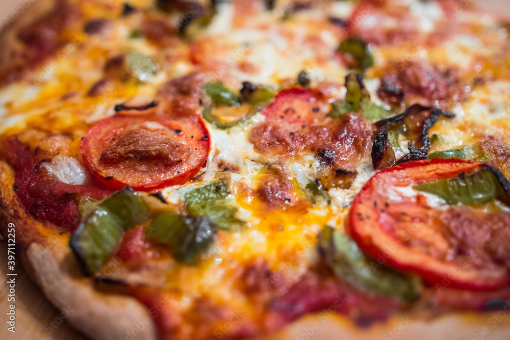 Most beautiful and delicious homemade vegetarian pizza just getting out of the pizza oven (marinara sauce, tomatoes, green peppers, mozarella cheese). Professional italian cooking. Macro close up. Most beautiful and delicious homemade vegetarian pizza just getting out of the pizza oven (marinara sauce, tomatoes, green peppers, mozarella cheese). Professional italian cooking. Macro close up.