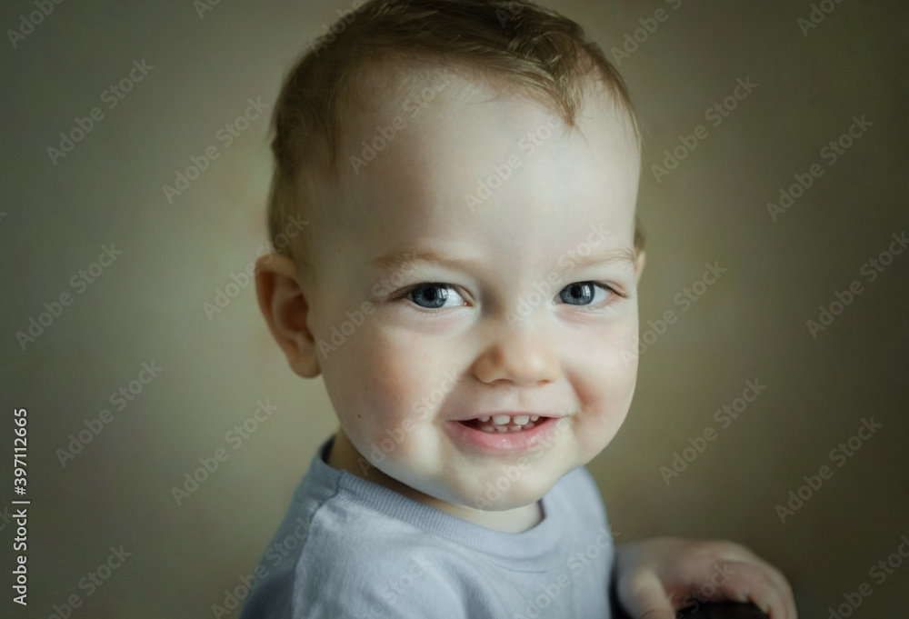 Emotion of joy.Photo portrait of a little smiling two-year-old boy in a T-shirt. Photo of a child with blue eyes, photo with a vignette effect. The concept of raising children, happy childhood Emotion of joy.Photo portrait of a little smiling two-year-old boy in a T-shirt. Photo of a child with blue eyes, photo with a vignette effect. The concept of raising children, happy childhood