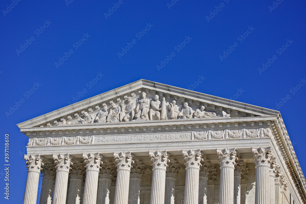 West pediment of the exterior of the US Supreme Court building in Washington, DC with Copy Space of sky above