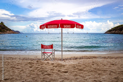 Lifeguard Chair and parasol at empty beach of Fetovaia, Island of Elba, Tuscany, Italy; swimmers rescue and safety concept