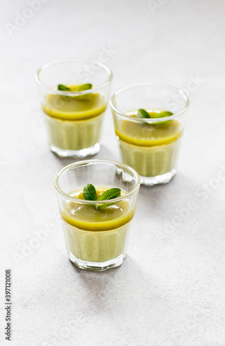 Italian Panna Cotta green matcha tea in a glass on a light gray background