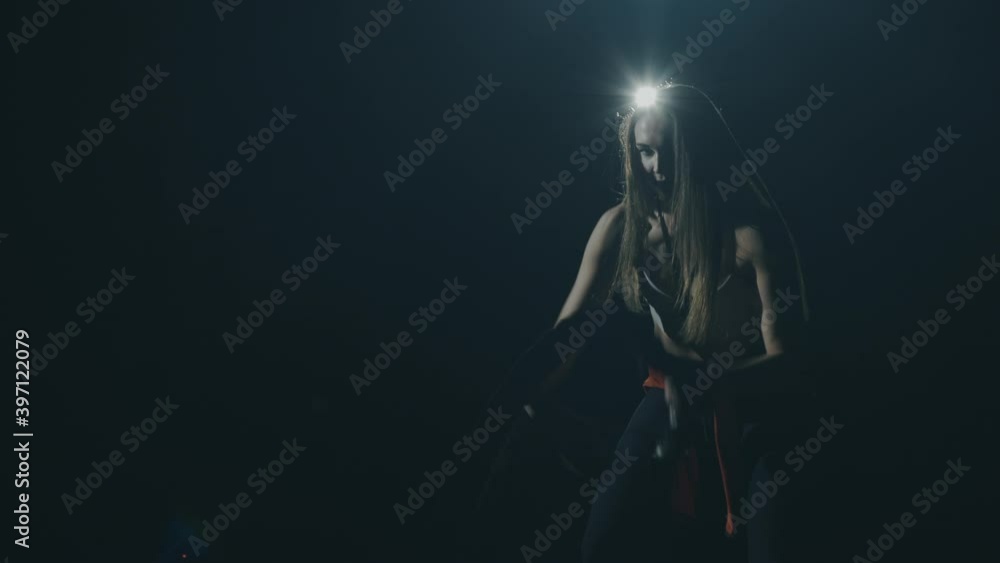 Beautiful athletic girl working out in gym, excercising with ropes. Gorgeous woman during crossfit training, showing determination and devotion to healthy lifestyle. Concept of muscles, beauty. Beautiful athletic girl working out in gym, excercising with ropes. Gorgeous woman during crossfit training, showing determination and devotion to healthy lifestyle. Concept of muscles, beauty.