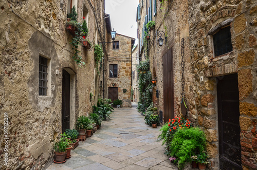 Beautiful view of old traditional houses and idyllic alleyway in the historic town. Italy