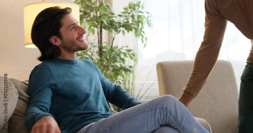 Gay man proposing boyfriend with an surprise engagement ring in red box at home Gay man proposing boyfriend with an surprise engagement ring in red box at home