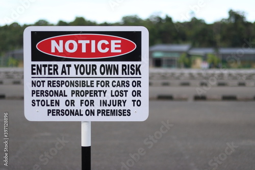 Valokuva enter at your own risk notice sign