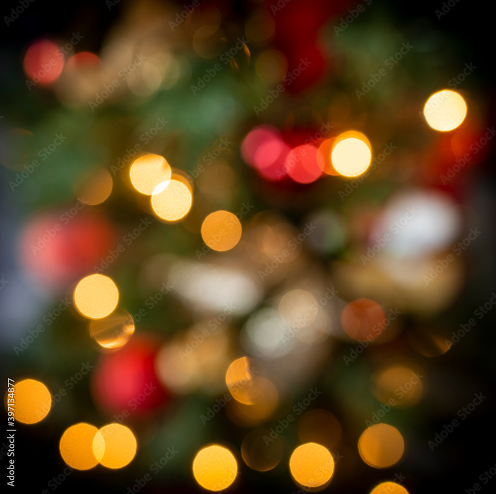 Bokeh Christmas tree light. Blurry lens of colorful Christmas decoration. Abstract beautiful defocused party effect background.