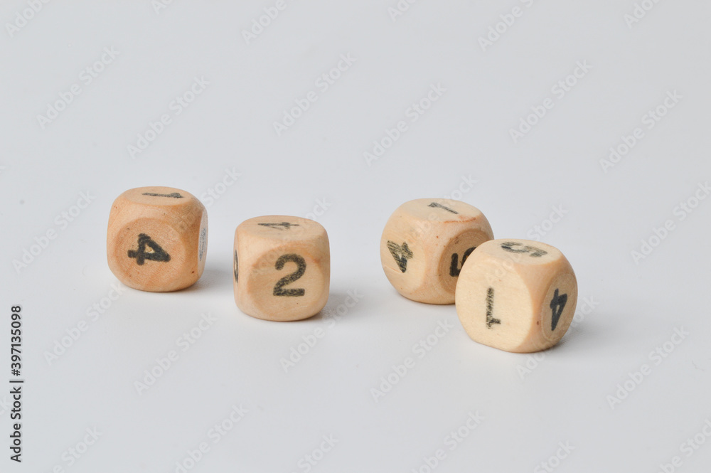 Selective focus of wooden dice isolated on a white background. Selective focus of wooden dice isolated on a white background.