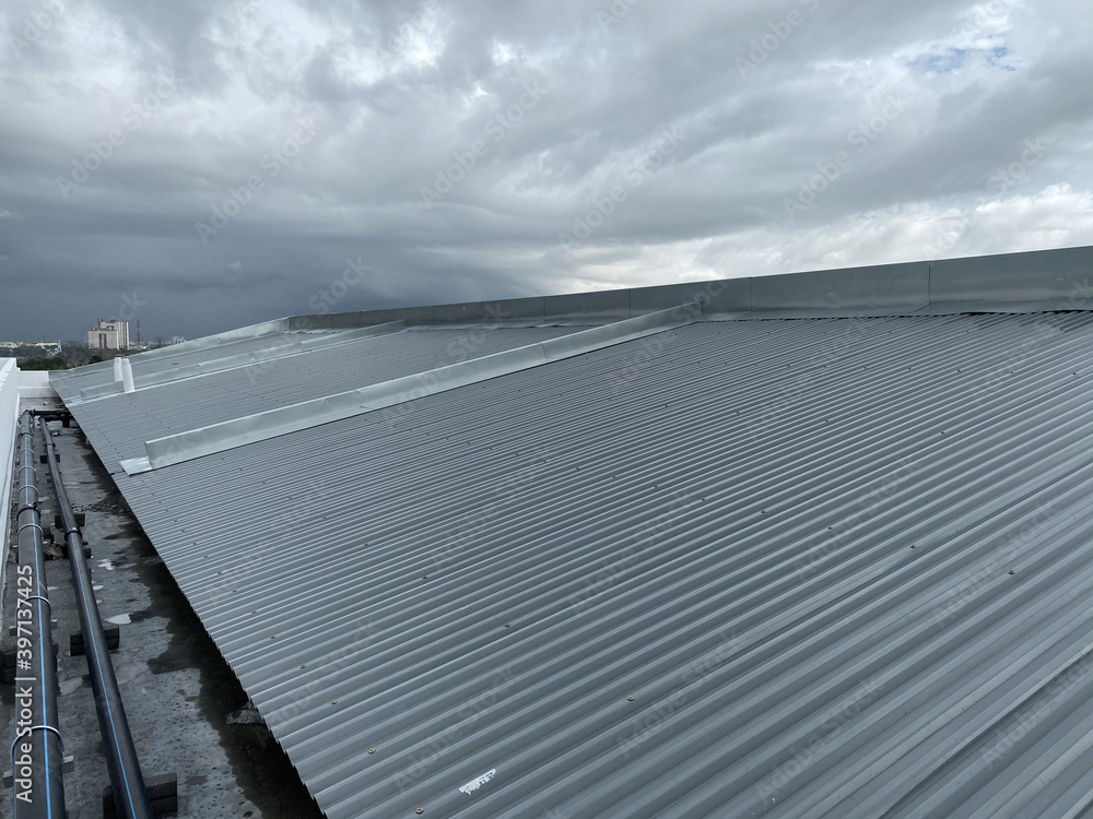 corrugated metal deck roof system with galvanised iron sheets installed on a building