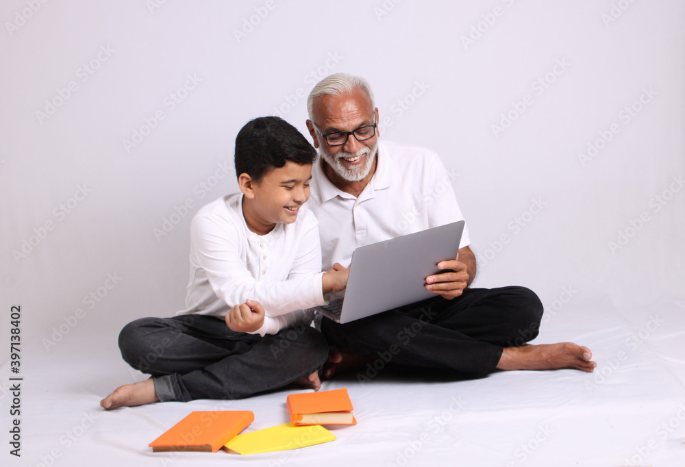 Indian grandfather teaching grandson home schooling or tuition. Indian grandfather teaching grandson home schooling or tuition.