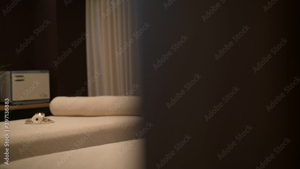 A revealing view of 2 beds of a romantic and relaxing spa cabin.