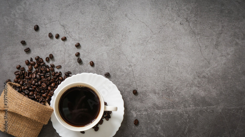 Coffee cup and beans on old kitchen table. Top view with copyspace for your text