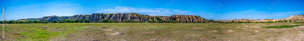 Panoramic view of a prairie dog town in lowlands with expansive bluffs of the badlands at Theodore Roosevelt National Park in North Dakota, USA