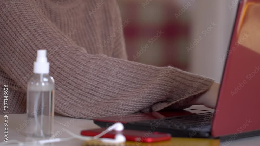 student doing disinfection with a sanitizer with alcohol. Disinfects hands and keyboard. student doing disinfection with a sanitizer with alcohol. Disinfects hands and keyboard.