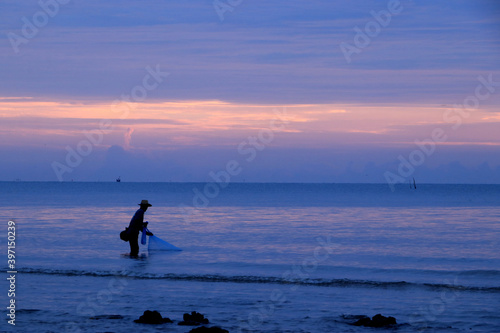 The fishermen are pulling the nets that are sown into the sea for fish. © Napatsorn