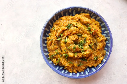Baigan Bharta, also called Vangyache Bharit in Marathi. It is a roasted eggplant curry. Brinjal chutney. served in a wooden bowl with rice roti or tandalachi bhakri. copy space.