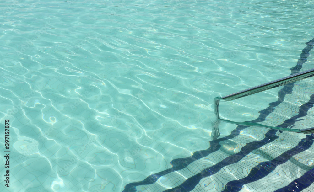 Obraz premium Swimming pool with stair steps and Handrail at the bottom right side