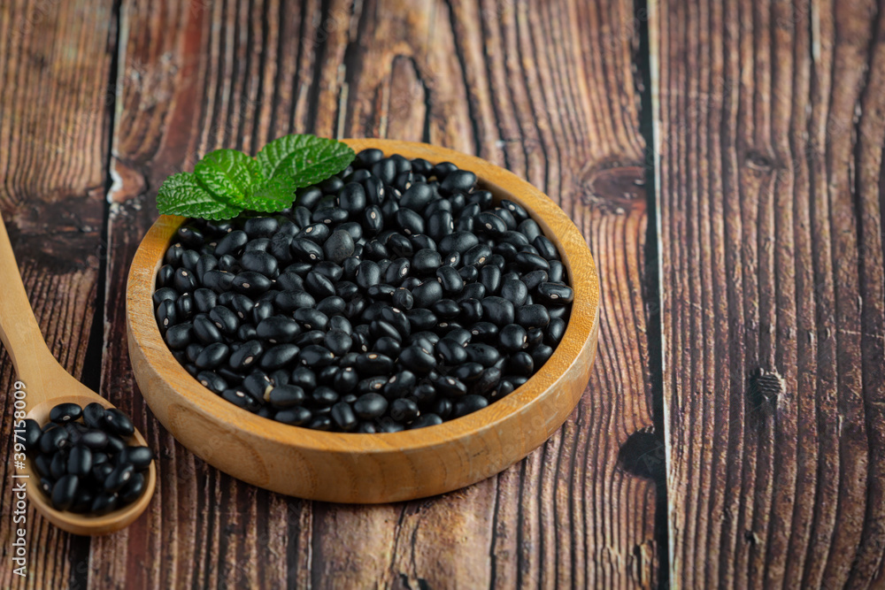 black bean in small wooden plate place on wooden floor black bean in small wooden plate place on wooden floor