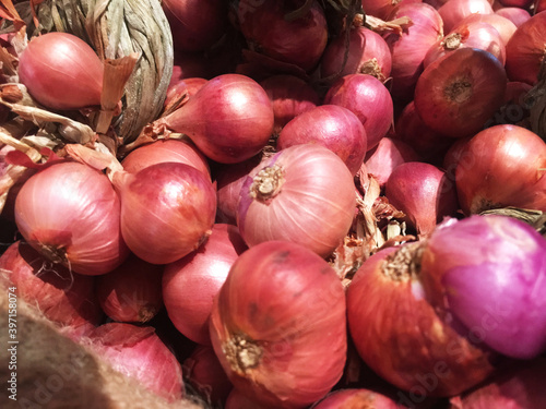 Red onions in plenty on display at local farmer's market, Big fresh red onions background