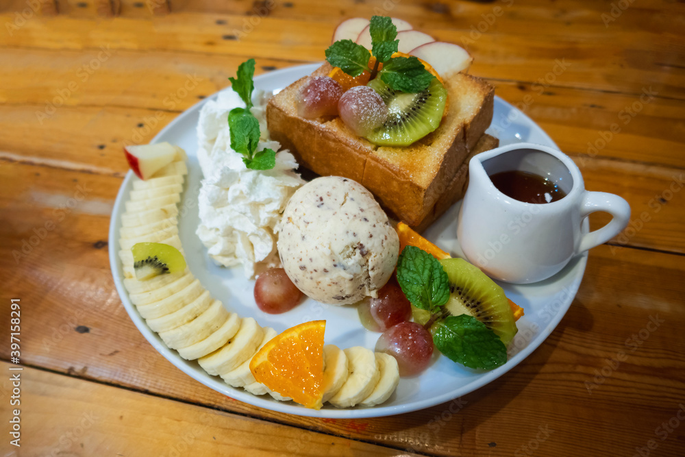 ice cream set with honey toast set on white dish put on wood table ice cream set with honey toast set on white dish put on wood table